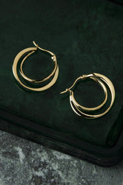A model wearing the Eclipse Yellow Gold Hoop Earrings in colour Gold (Metallics), from the front, showing the whole outfit