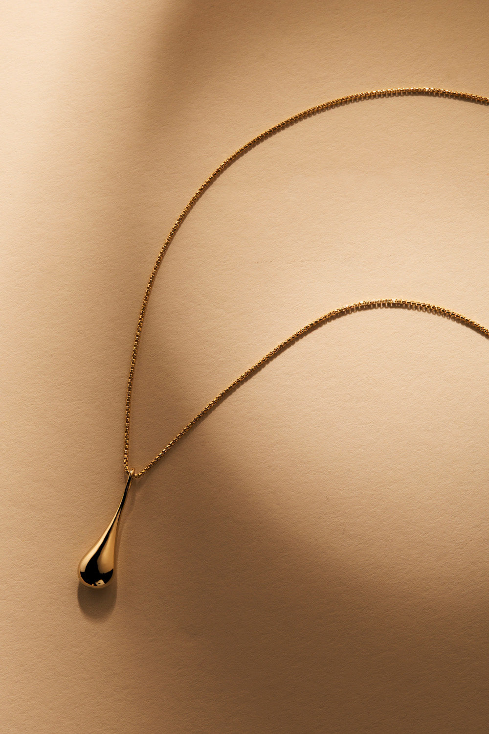 A model wearing the My Silent Tears Necklace in colour Gold (Metallics), from the front, showing the whole outfit