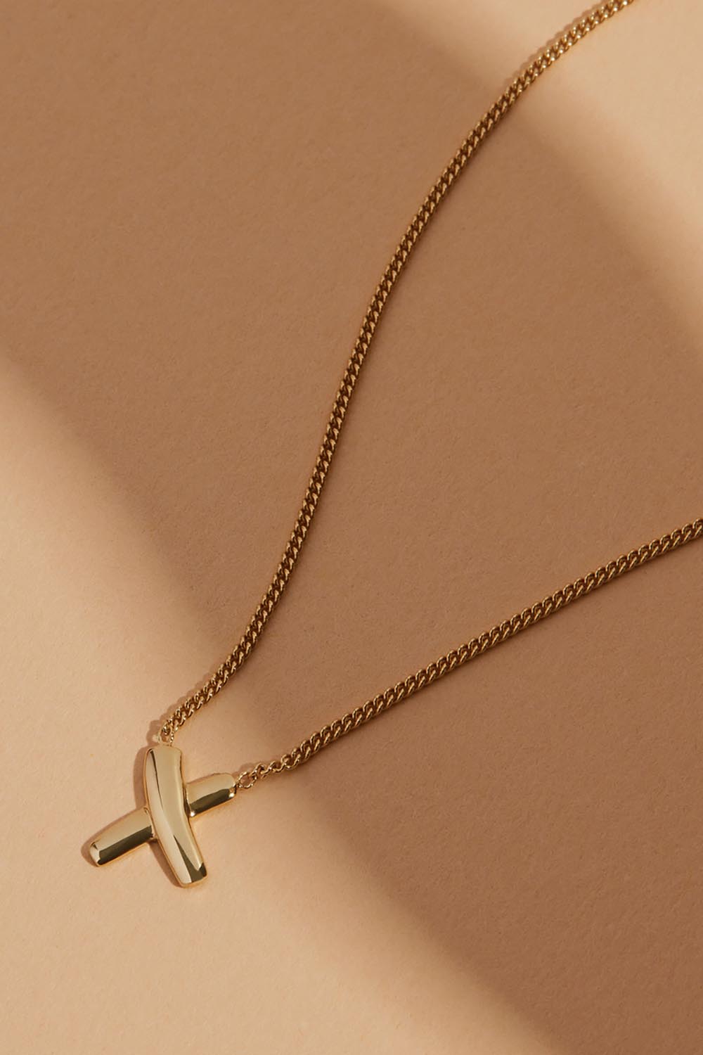 A model wearing the Bisous Yellow Gold Necklace in colour Gold (Metallics), from the front, showing the whole outfit