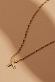 A model wearing the Bisous Yellow Gold Necklace in colour Gold (Metallics), from the front, showing the whole outfit