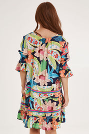 Model Sally wearing size S of the Kasbah Dress in colour Basque (Blue), from the back