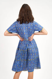 A model wearing the Libra Dress in colour Patolablue (Blue), from the back