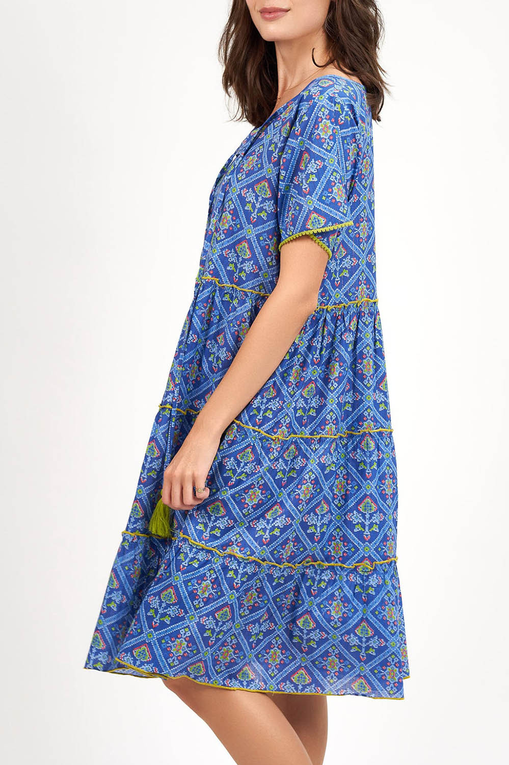 A model wearing the Libra Dress in colour Patolablue (Blue), from the front, cropped image
