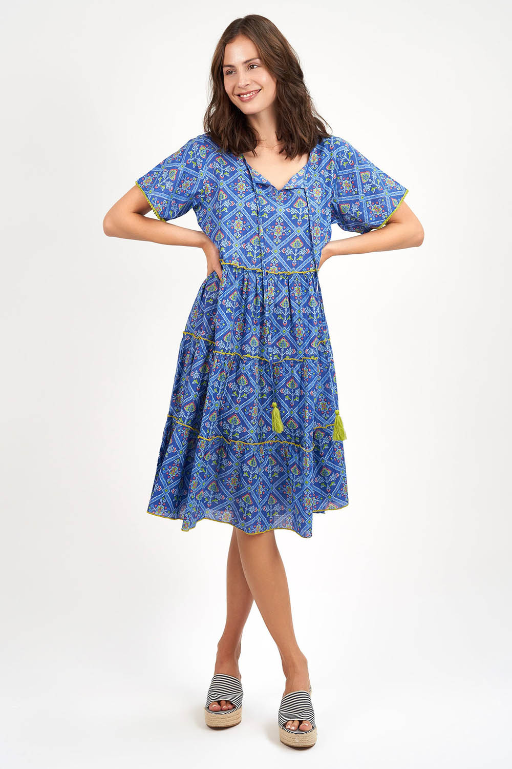 A model wearing the Libra Dress in colour Patolablue (Blue), from the front, showing the whole outfit