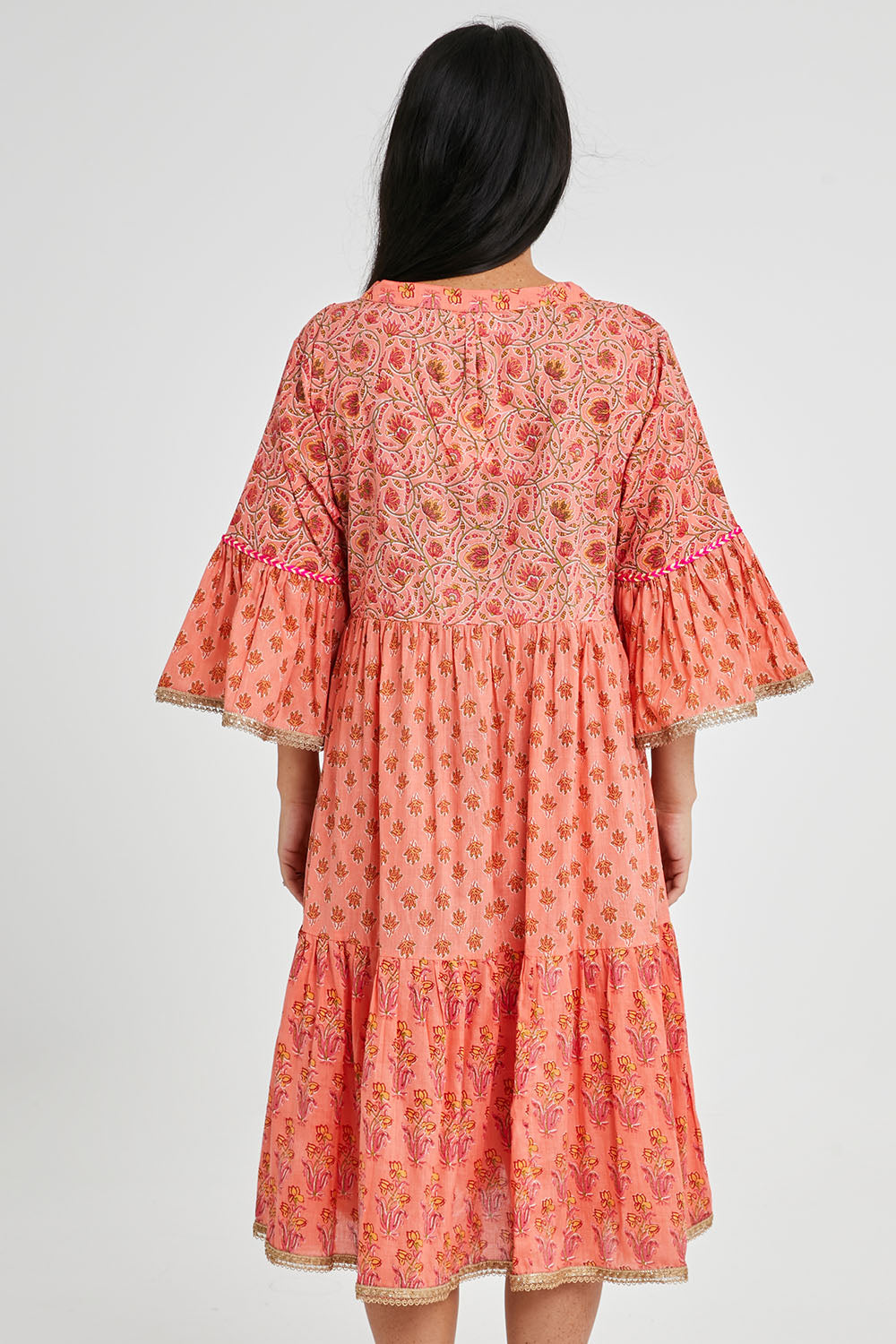 Model Katie wearing size S of the Belmont Dress in colour Coralpatch (Pink), from the back