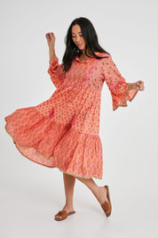 Model Katie wearing size S of the Belmont Dress in colour Coralpatch (Pink), from the front, showing the whole outfit