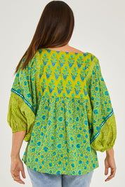 Model Georgia wearing size S of the Bahamas Top in colour Islalime (Green), from the back