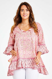 Model Laura wearing size L of the Hacienda Tunic in colour Pink (Pink), from the front, cropped image