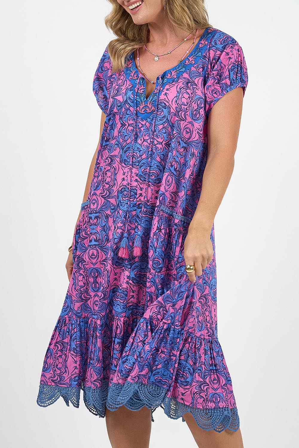 A model wearing the Sao Paulo Cotton Dress in colour Alessipink, from the front, cropped image