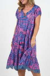 A model wearing the Sao Paulo Cotton Dress in colour Alessipink, from the front, cropped image