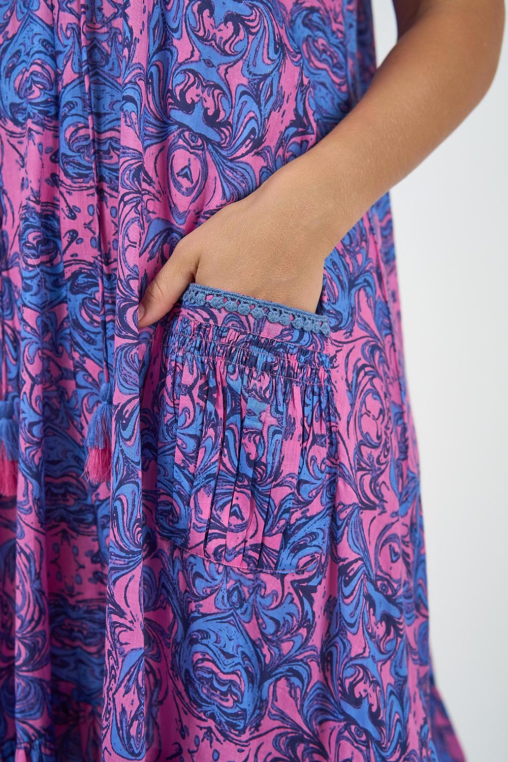A model wearing the Sao Paulo Cotton Dress in colour Alessipink, from the front, cropped image