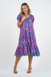 A model wearing the Sao Paulo Cotton Dress in colour Alessipink, from the front, showing the whole outfit