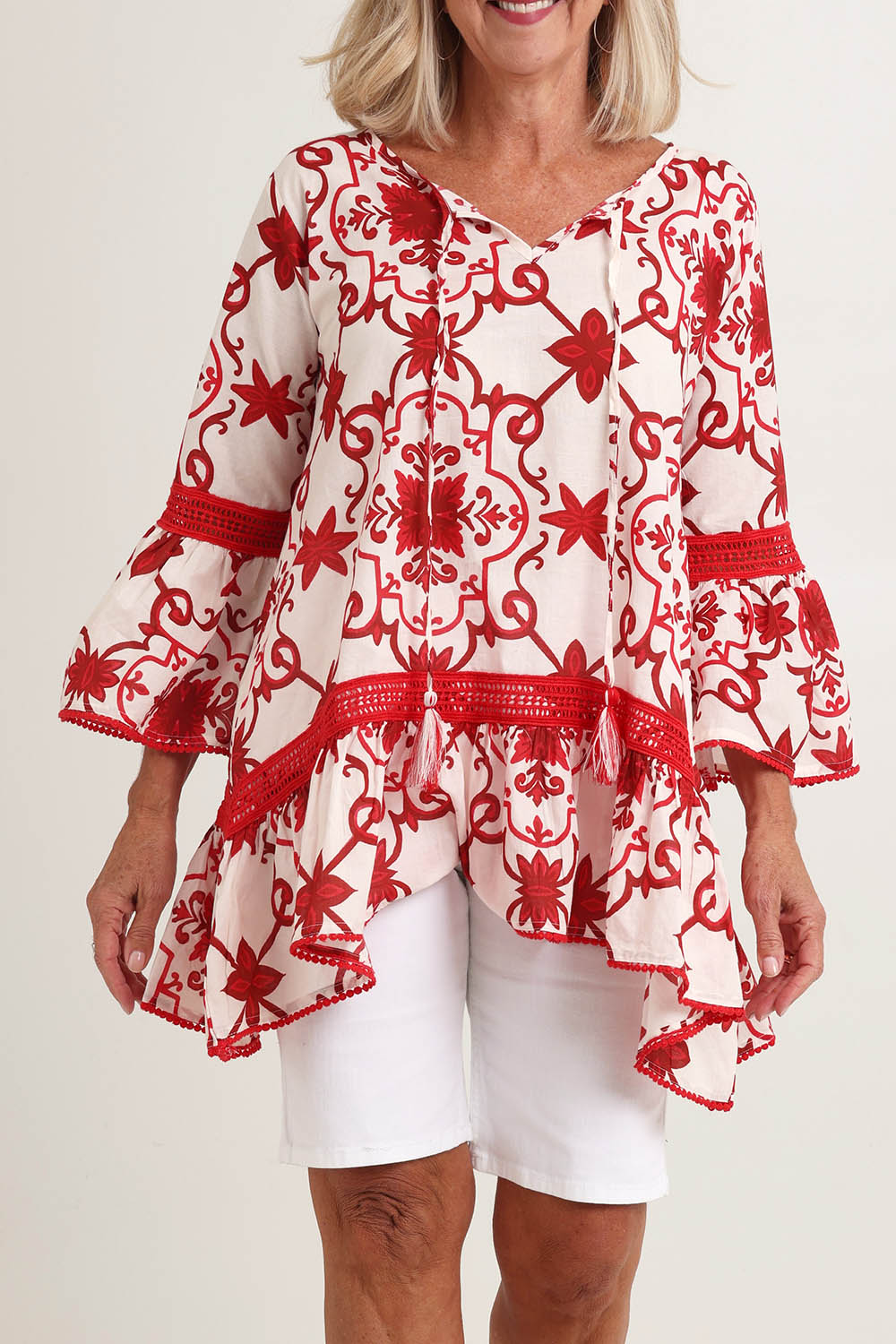 Model Fiona wearing size S of the Hacienda Cotton Tunic in colour Jemmared (Red), from the front, cropped image