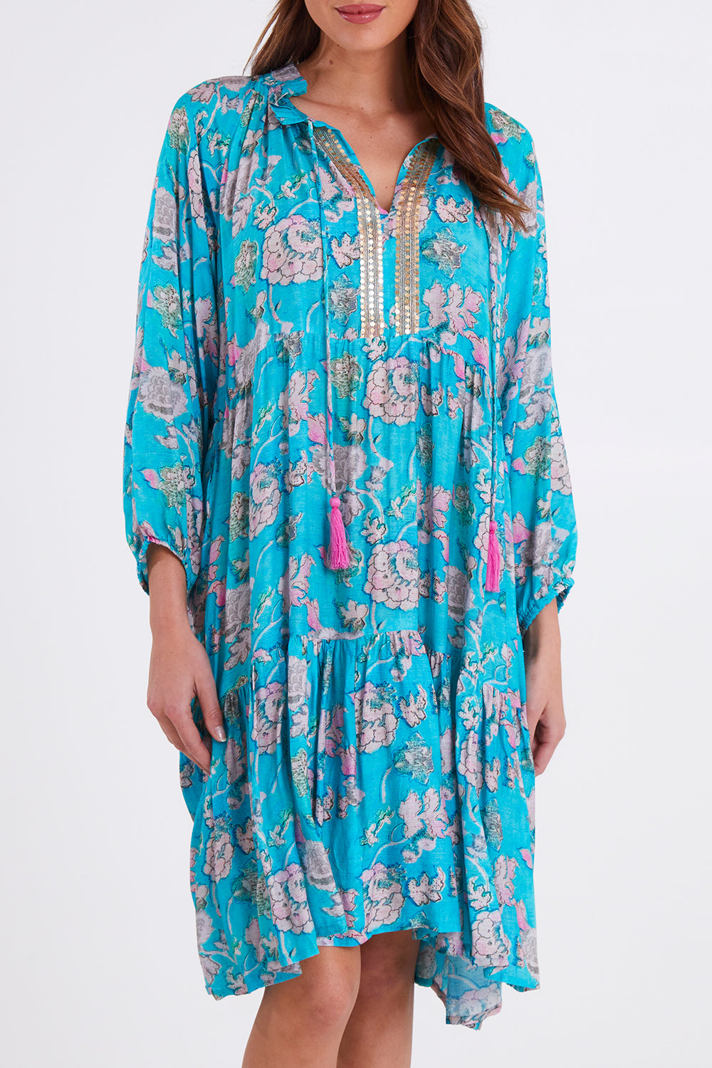 Model Madeline wearing size S of the Molly Dress in colour Derpink (Blue), from the front, cropped image
