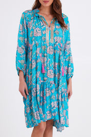 Model Madeline wearing size S of the Molly Dress in colour Derpink (Blue), from the front, cropped image
