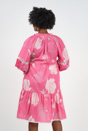 A model wearing the Molly Cotton Dress in colour Petal (Pink), from the back