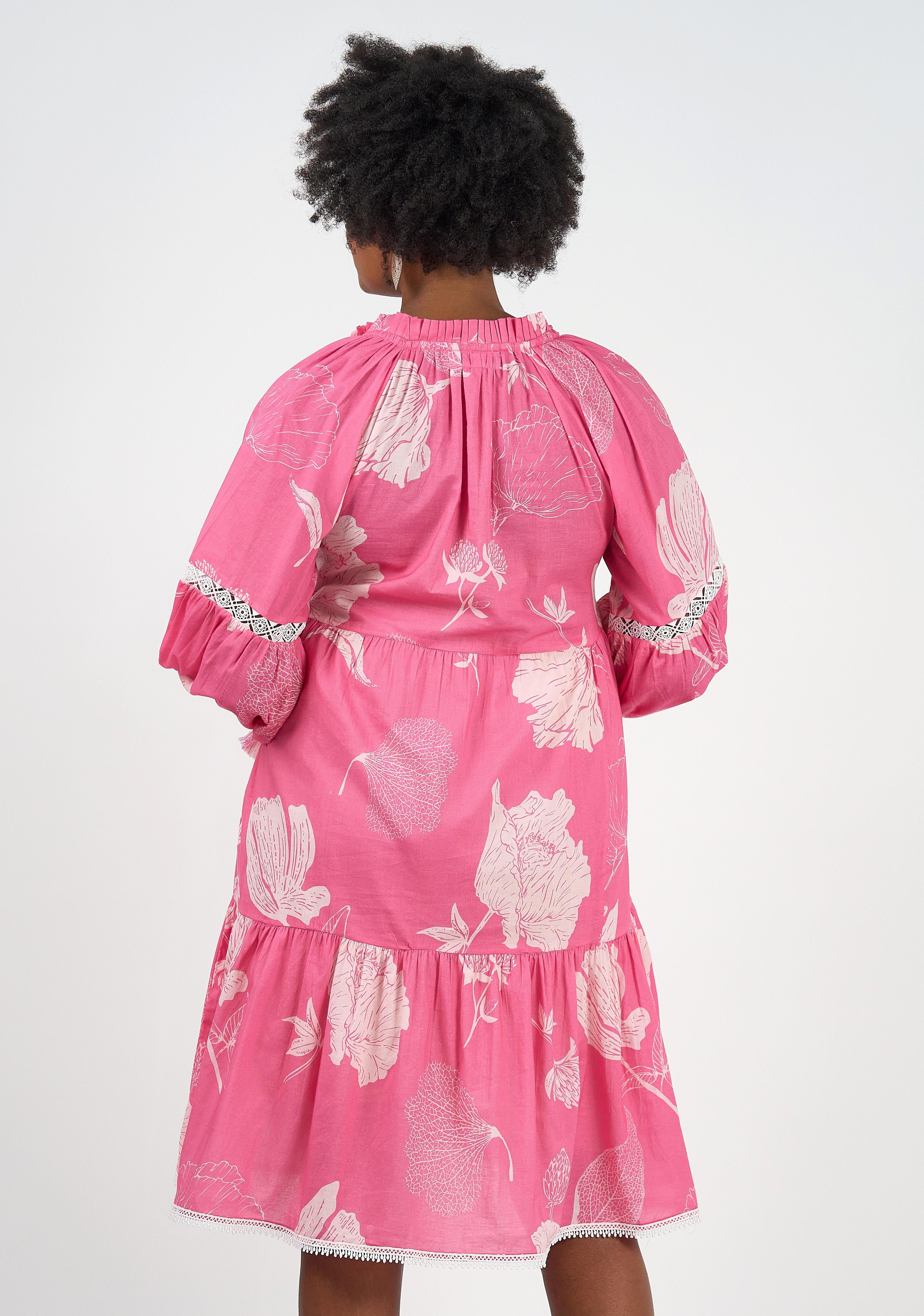 A model wearing the Molly Cotton Dress in colour Petal (Pink), from the back