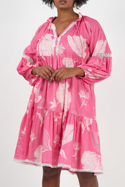 A model wearing the Molly Cotton Dress in colour Petal (Pink), from the front, cropped image