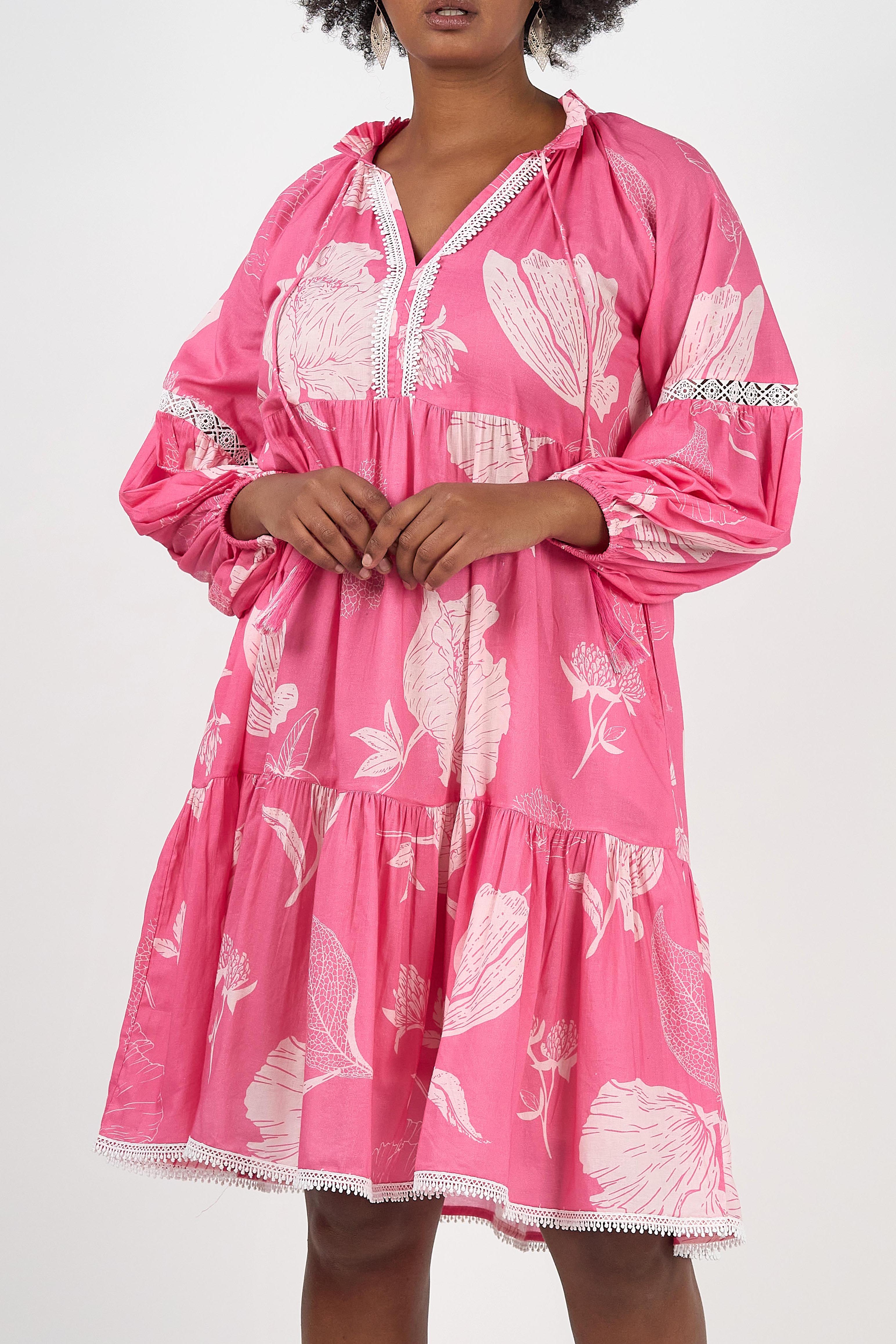 A model wearing the Molly Cotton Dress in colour Petal (Pink), from the front, cropped image