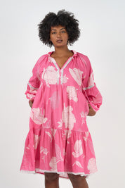 A model wearing the Molly Cotton Dress in colour Petal (Pink), from the front, cropped image