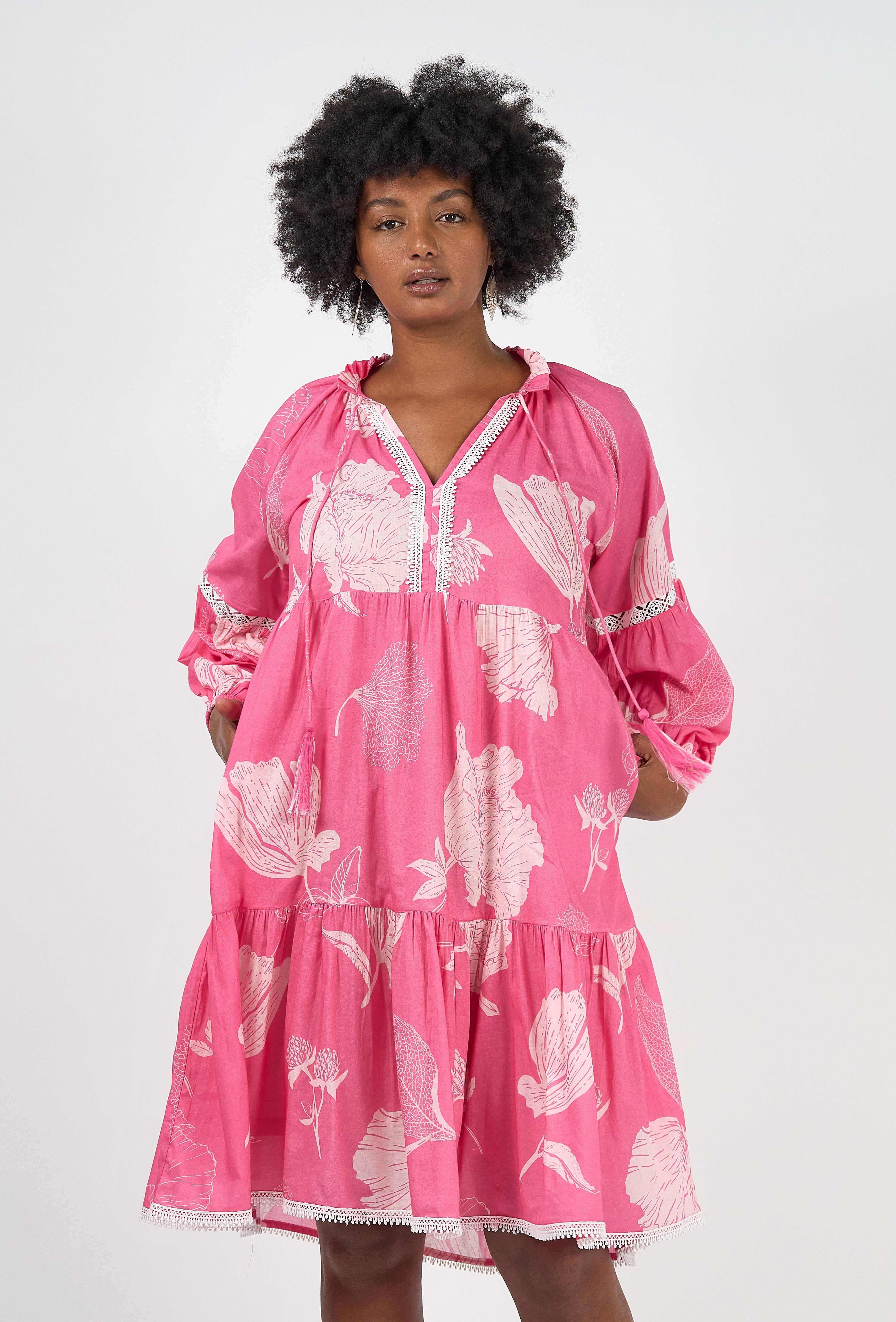 A model wearing the Molly Cotton Dress in colour Petal (Pink), from the front, cropped image