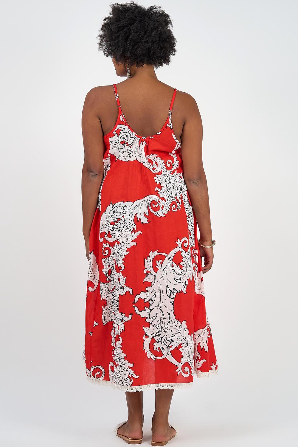 A model wearing the Astrid Cotton Maxi Dress in colour Pompeiired (Red), from the back