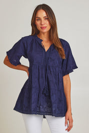 Model Madeline wearing size S of the Matilda Cotton Short Sleeve Top in colour Paisleynav (Blue), from the front, cropped image