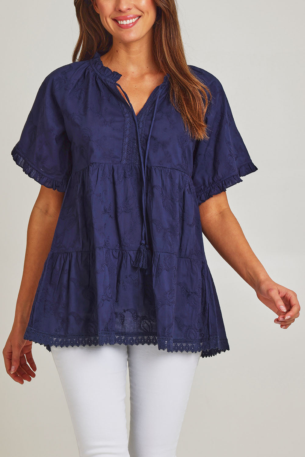 Model Madeline wearing size S of the Matilda Cotton Short Sleeve Top in colour Paisleynav (Blue), from the front, cropped image