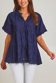 Model Madeline wearing size S of the Matilda Cotton Short Sleeve Top in colour Paisleynav (Blue), from the front, cropped image