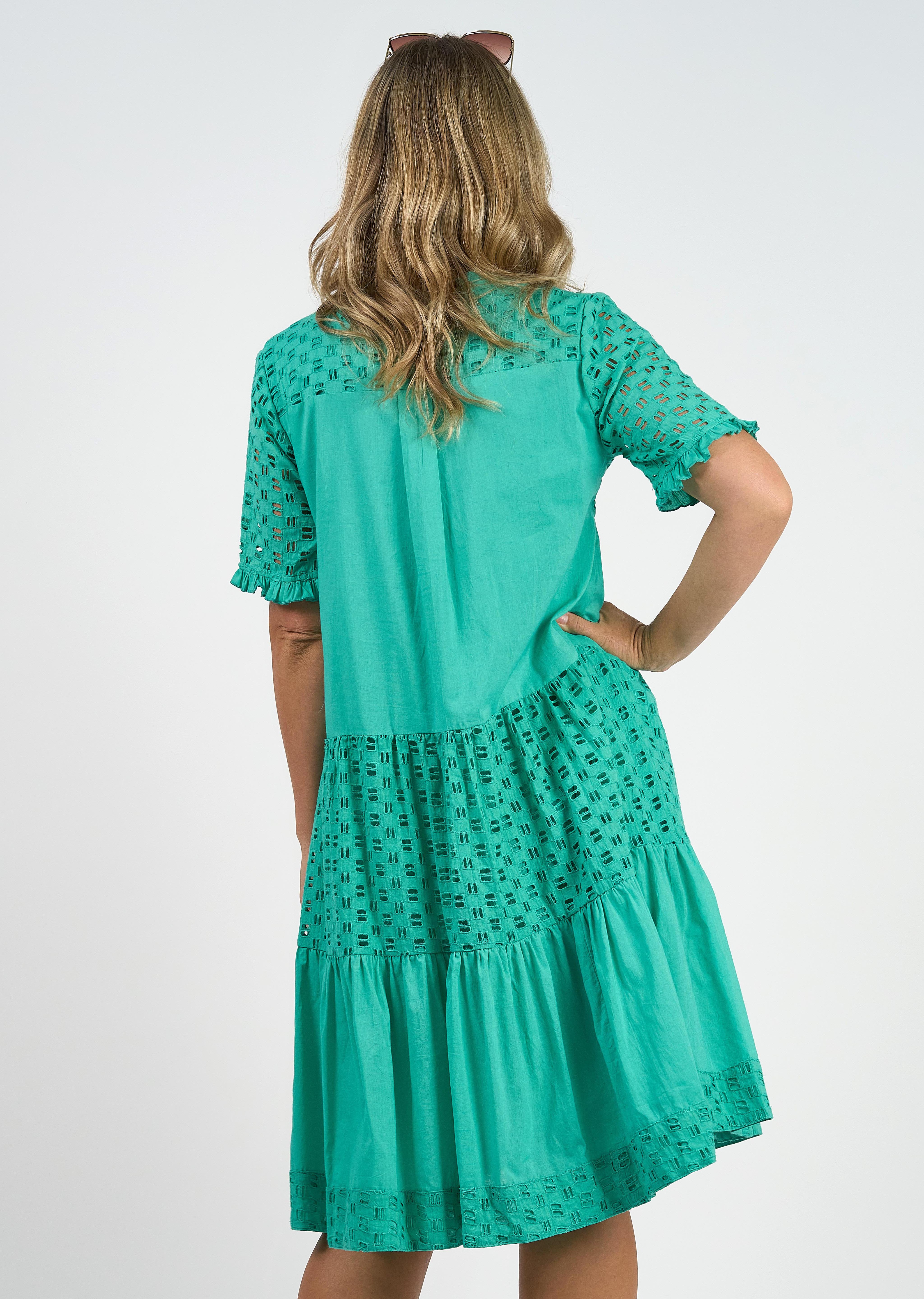 A model wearing the Heather S/S Cotton Dress in colour Luca (Green), from the back