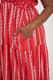A model wearing the Frida Cotton Maxi Dress in colour Sorrento (Red), from the front, cropped image