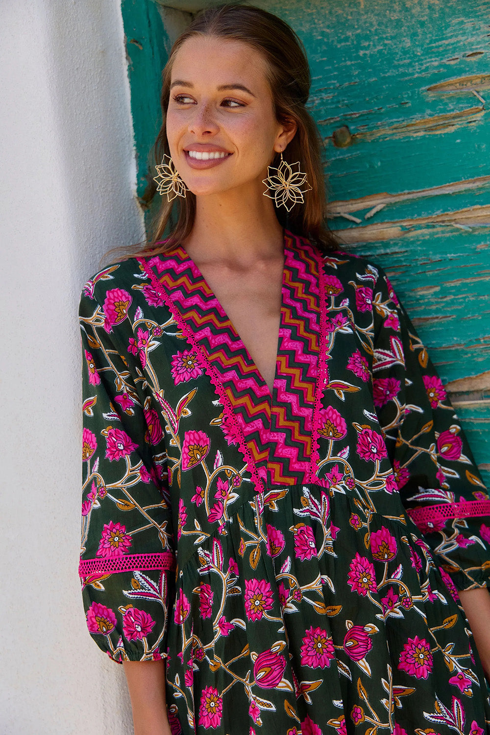 A model wearing the Penny Cotton Maxi Dress in colour Jewel (Green), from the front, cropped image