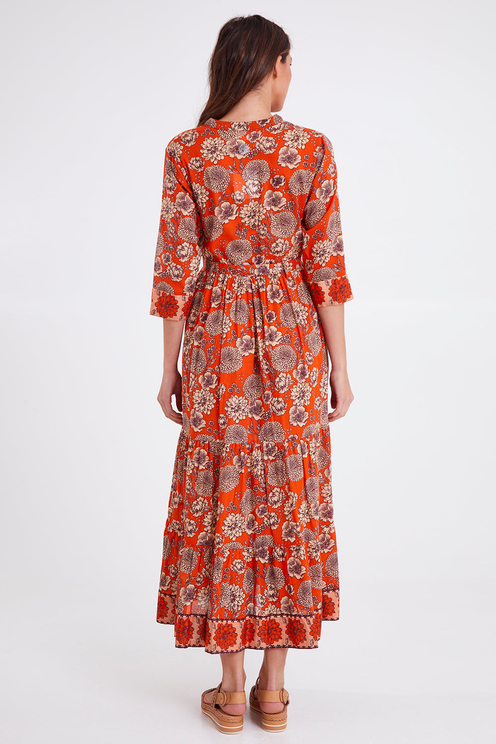 Model Madeline wearing size S of the Leela Dress in colour Orange, from the back