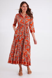 Model Madeline wearing size S of the Leela Dress in colour Orange, from the front, showing the whole outfit