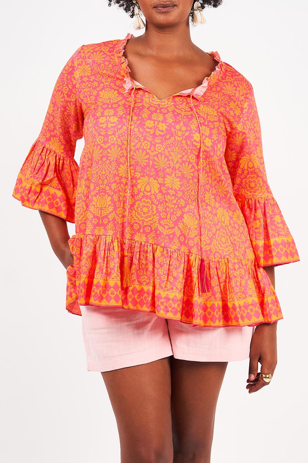 A model wearing the Hacienda Cotton Tunic in colour Majestic (Pink), from the front, cropped image
