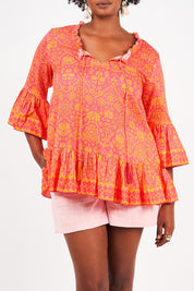 A model wearing the Hacienda Cotton Tunic in colour Majestic (Pink), from the front, cropped image