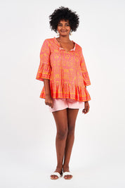 A model wearing the Hacienda Cotton Tunic in colour Majestic (Pink), from the front, showing the whole outfit
