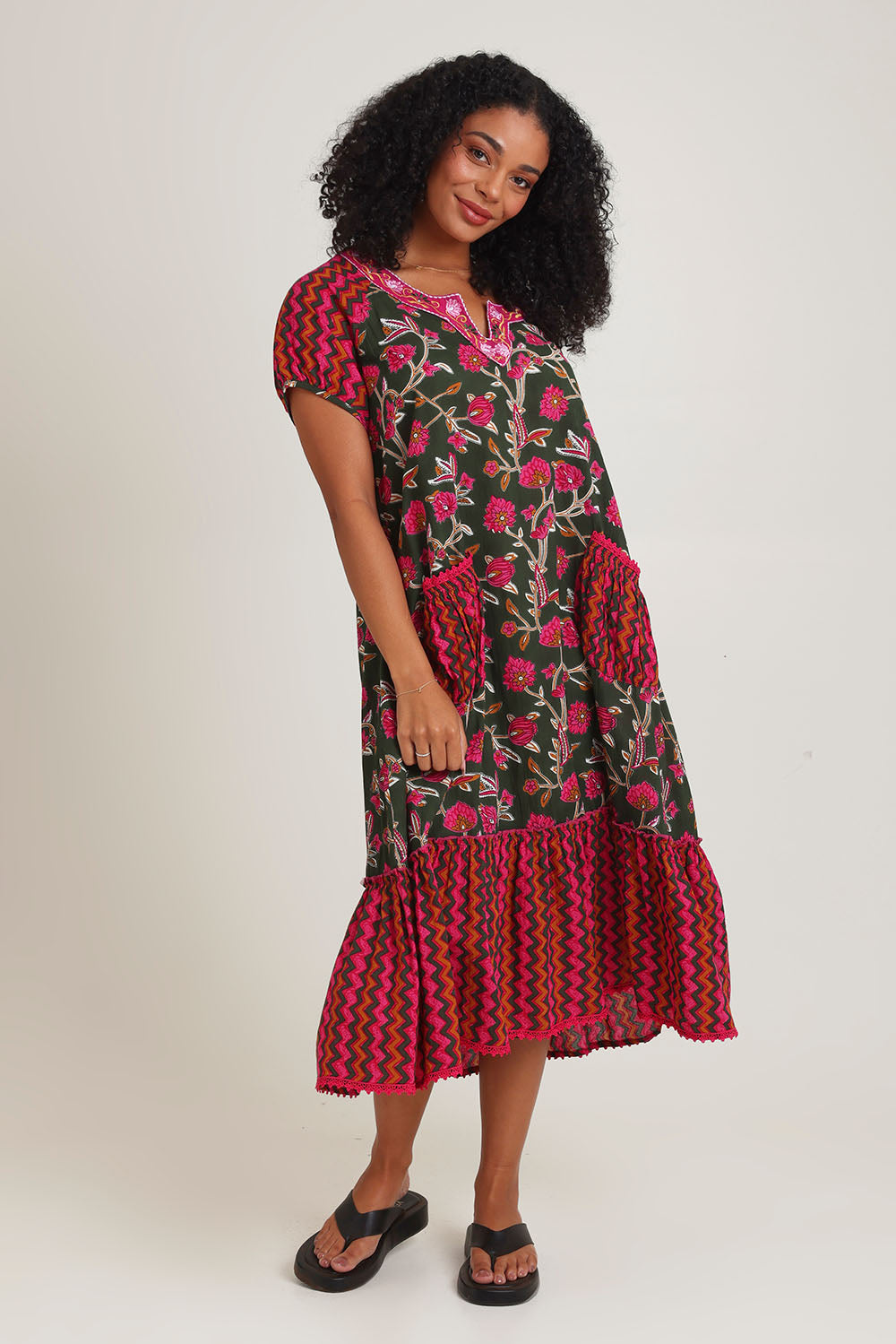 Model Ziara wearing size S of the Sao Paulo Cotton Midi Dress in colour Jewel (Green), from the front, showing the whole outfit