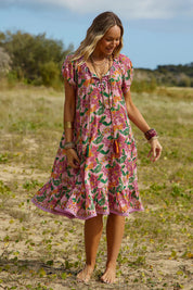 A model wearing the Sao Paulo Cotton Dress in colour Panama (Pink), from the front, showing the whole outfit