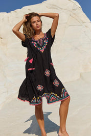 A model wearing the Sao Paulo Cotton Dress in colour Rubyblk (Black), from the front, showing the whole outfit