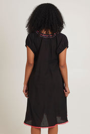 Model Ziara wearing size S of the Sao Paulo Cotton Dress in colour Rubyblk (Black), from the back