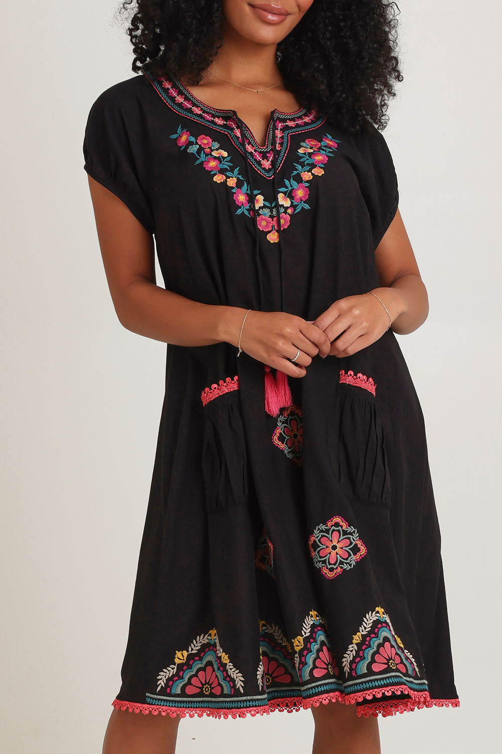 Model Ziara wearing size S of the Sao Paulo Cotton Dress in colour Rubyblk (Black), from the front, cropped image