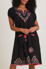Model Ziara wearing size S of the Sao Paulo Cotton Dress in colour Rubyblk (Black), from the front, cropped image