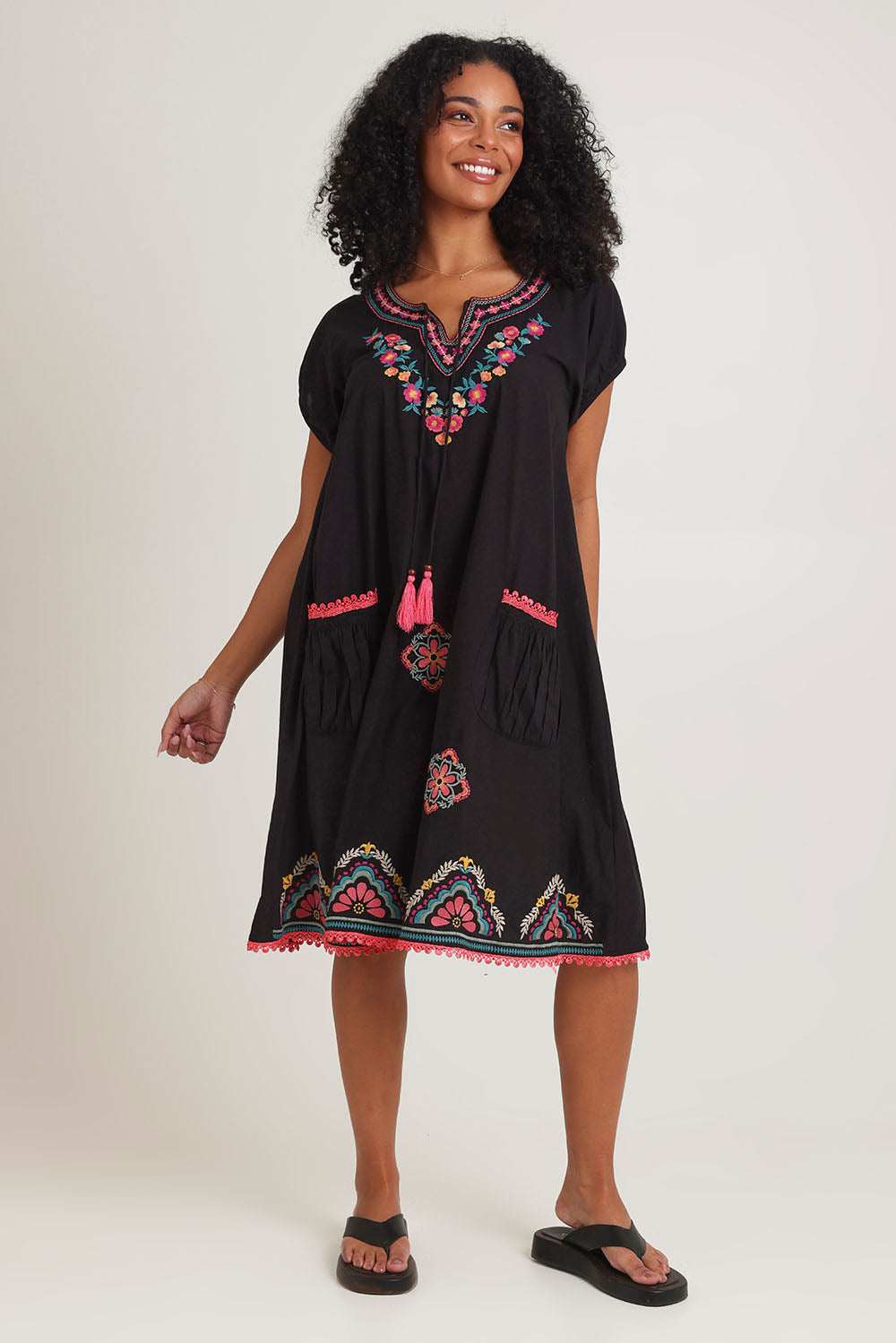 Model Ziara wearing size S of the Sao Paulo Cotton Dress in colour Rubyblk (Black), from the front, showing the whole outfit