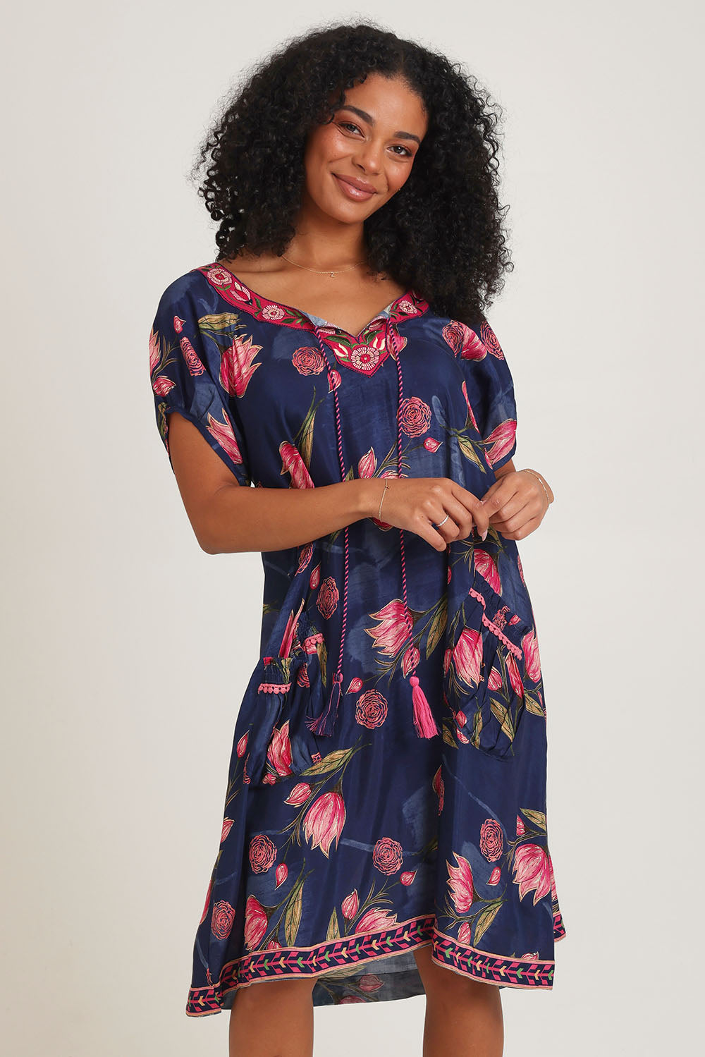 Model Ziara wearing size S of the Sao Paulo Dress in colour Frolic (Blue), from the front, cropped image