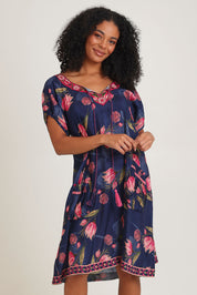 Model Ziara wearing size S of the Sao Paulo Dress in colour Frolic (Blue), from the front, cropped image