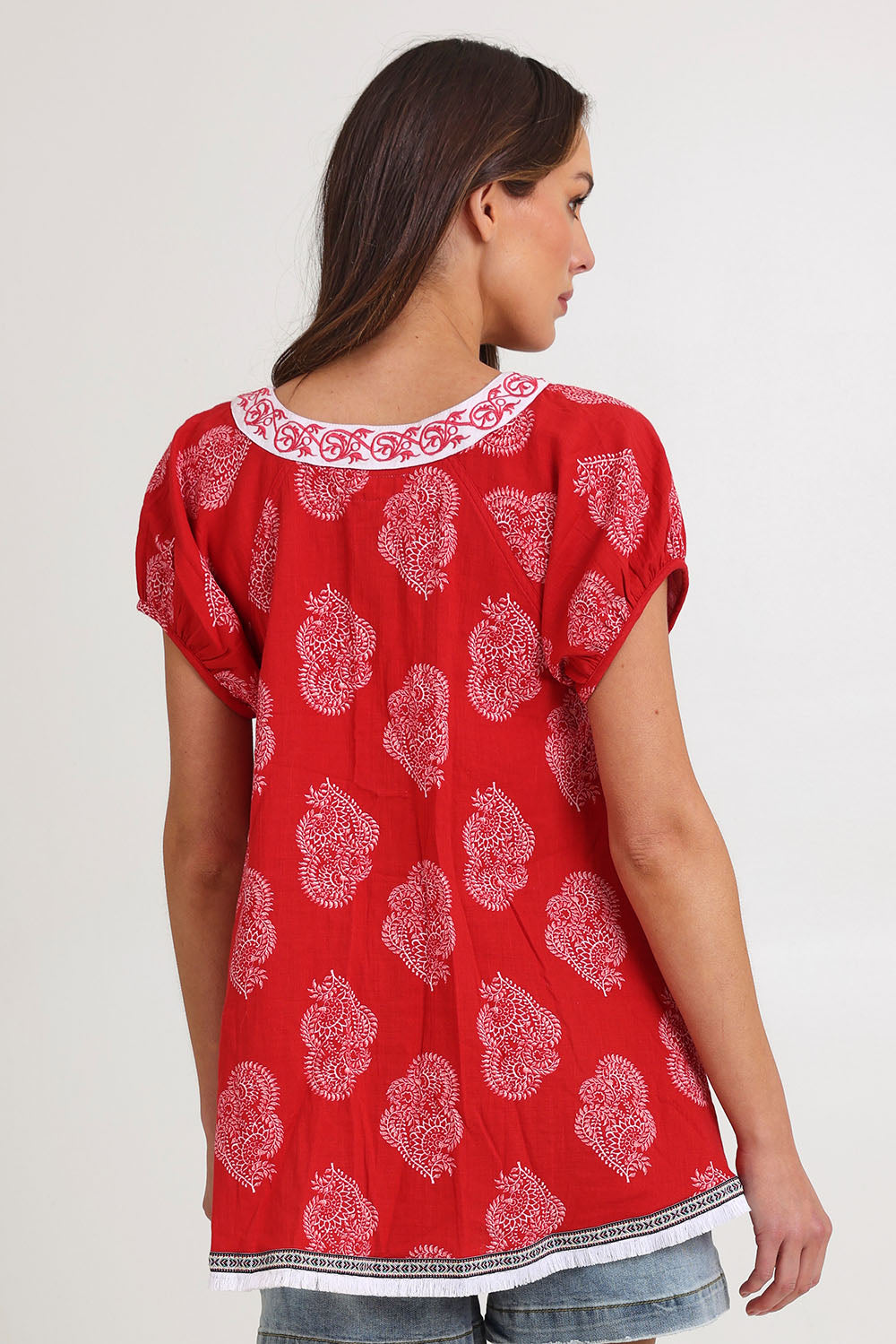 Model Madeline wearing size S of the Sao Paulo Cotton Top in colour Paisleyred (Red), from the back