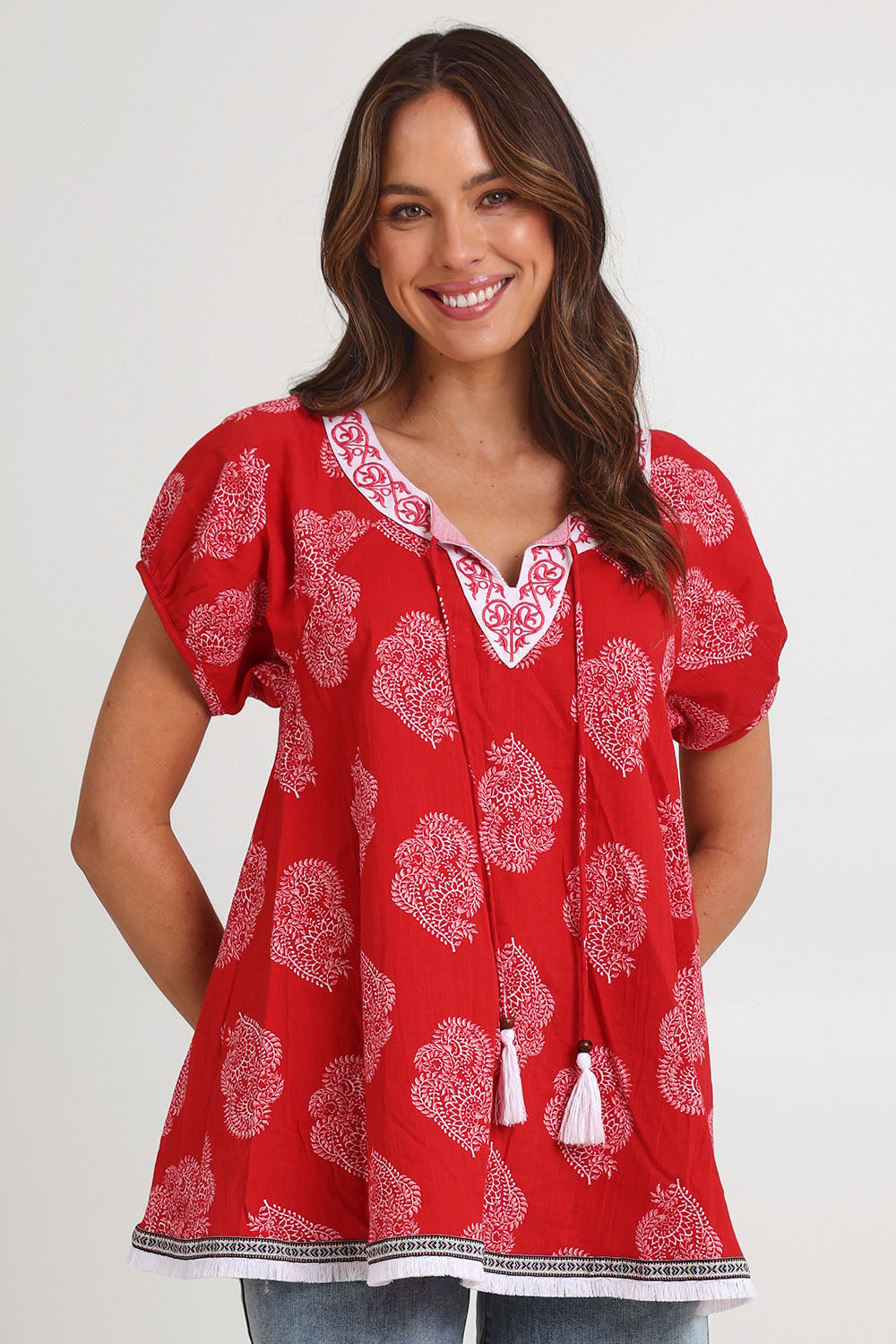 Model Madeline wearing size S of the Sao Paulo Cotton Top in colour Paisleyred (Red), from the front, cropped image