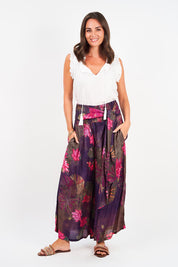 A model wearing the Hendrix Pant in colour Waterlily (Blue), from the front, showing the whole outfit
