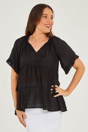 Model Georgia wearing size S of the Matilda Top in colour Black (Black), from the front, cropped image